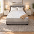 RV Short Queen Breeze Cool Max 10" Medium Firm Tight top mattress on a gray upholstered bed with two white pillows and a tan knit throw, in a bedroom with white nightstands, table lamps and a framed landscape print