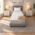 Twin XL Breeze Cool Max 10" Medium Firm Tight top mattress on a gray upholstered bed with a white pillow and a tan knit throw, in a bedroom with white nightstands, table lamps and a framed landscape print